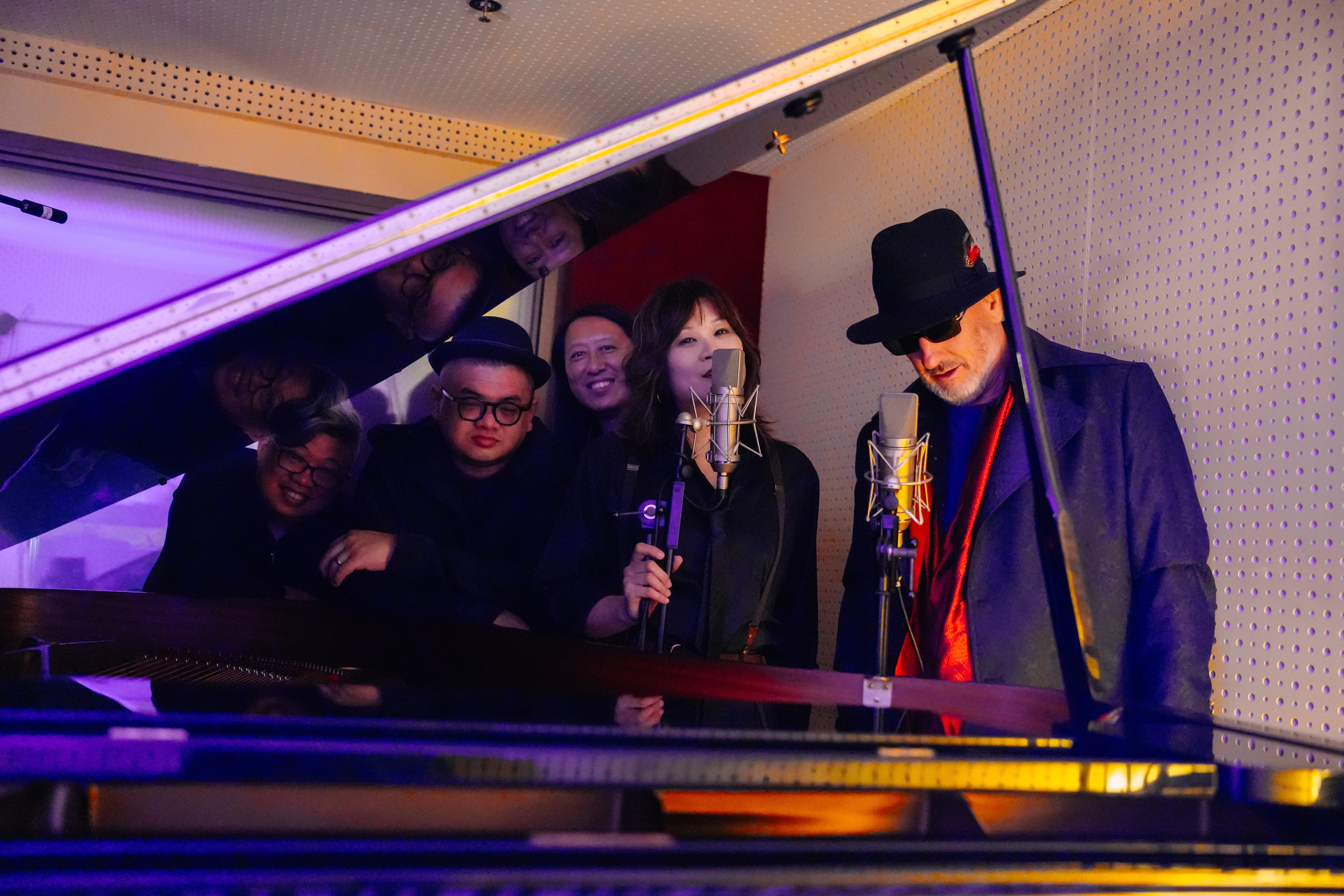 Zorin Morris band looking up through the lid of a grand piano