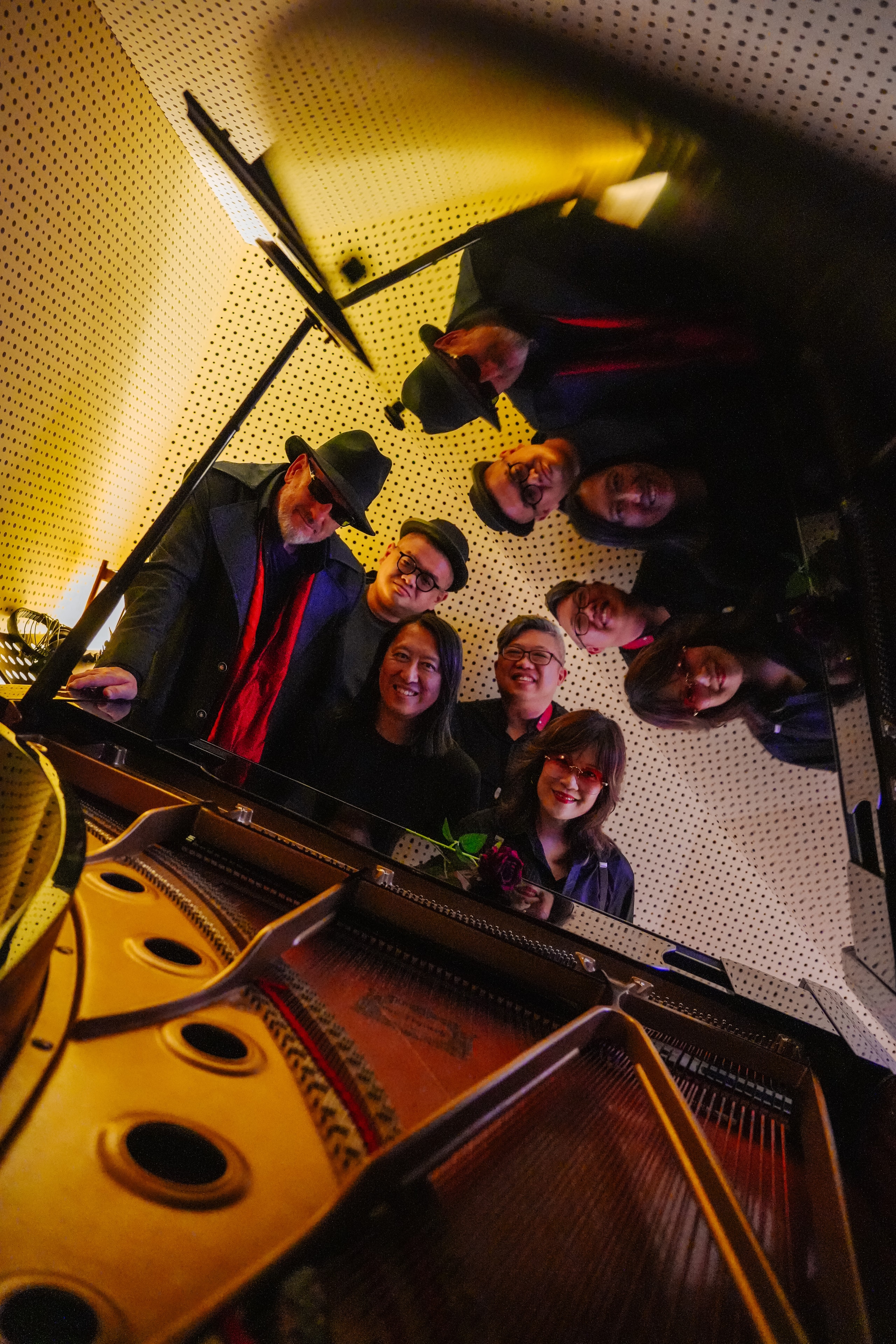 Zorin Morris band gathered around a grand piano in the studio